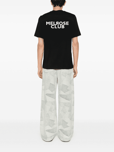 Back view of black Iconic monogram streetwear tee front & back print by Melrose Club