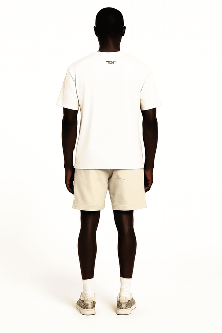 Rear view of man wearing Melrose Club black swan graphic tee in white with beige shorts and sneakers