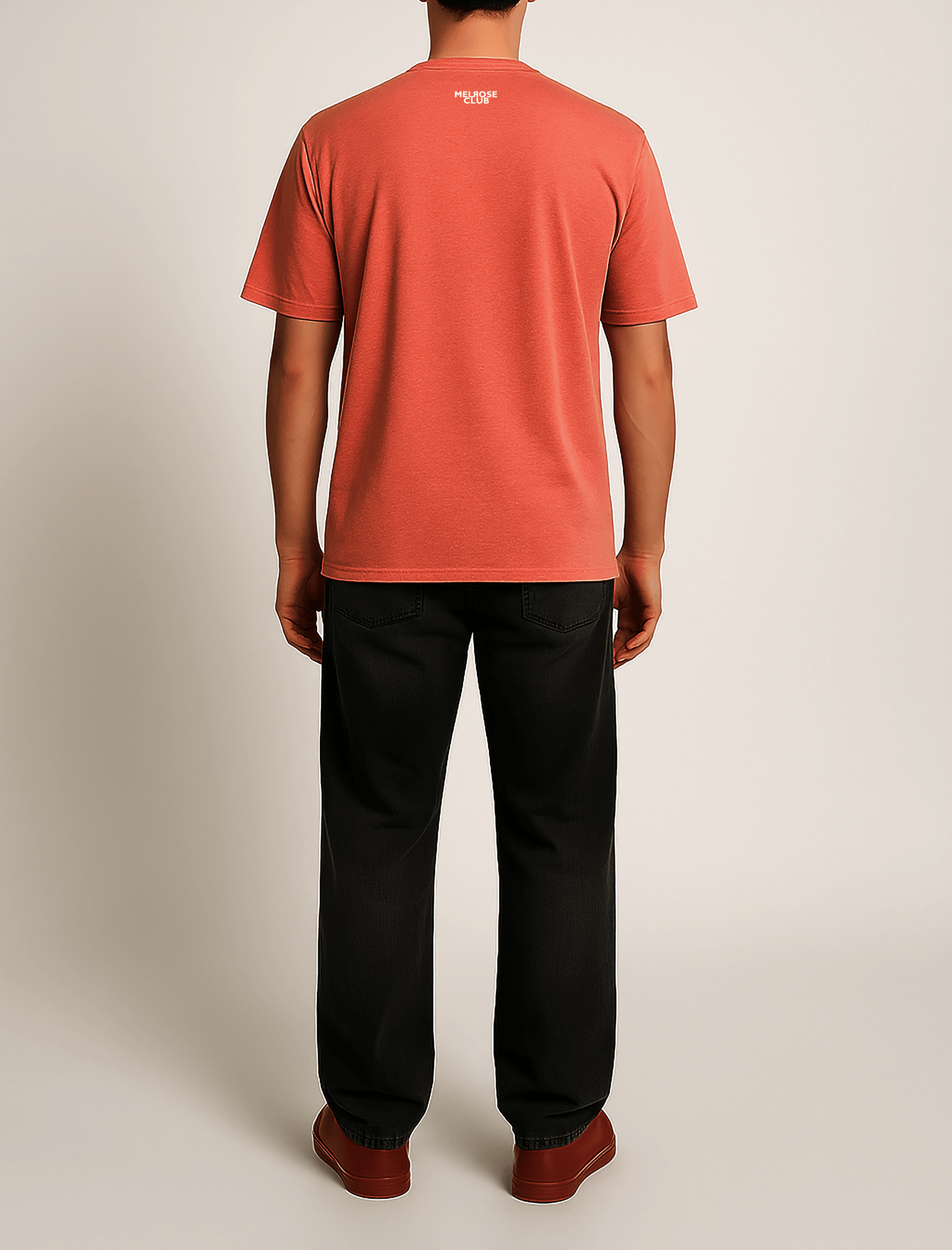 Men's Melrose Club coral nautical heart graphic tee displayed from the back with black pants for a casual look